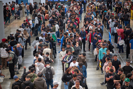 FILE - Migrants queue at a public service office to obtain paperwork needed to apply for Spain's immigration amnesty, in L'Hospitalet de Llobregat near Barcelona, Spain, on April 21, 2026. (AP Photo/Emilio Morenatti, File)